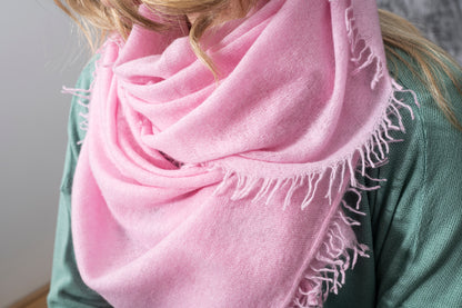 Shawl: Cashmere Hand Felted by Rayaa in soft pink draped around a woman.