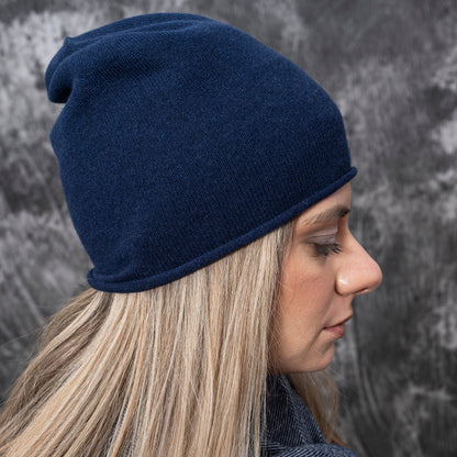 A closeup of a woman wearing cashmere Lightweight Reverse Knit Cap by Rayaa in Snow Blue color