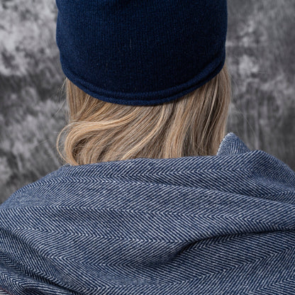 A closeup of a woman wearing cashmere Lightweight Reverse Knit Cap by Rayaa in Snow white color