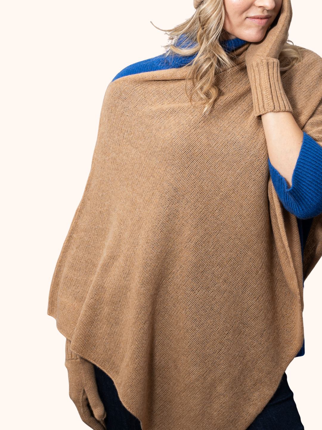 Woman wearing a stylish cashmere Poncho by Rayaa, showcasing an elegant and flattering silhouette.