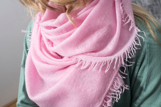 Shawl: Cashmere Hand Felted by Rayaa in soft pink draped around a woman.