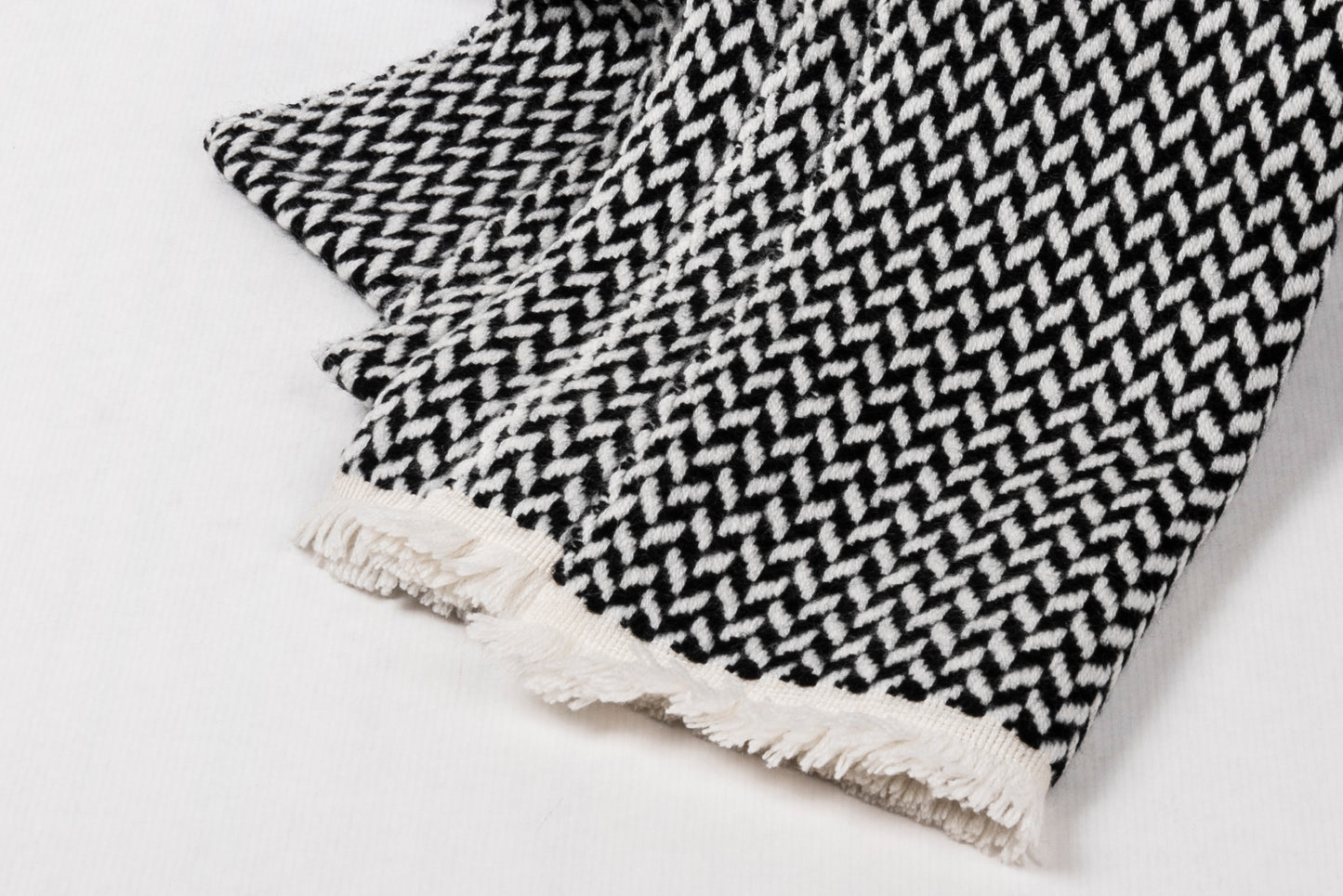 Cashmere Herringbone Narrow Shawl featuring a modern herringbone weave and fringed edges.